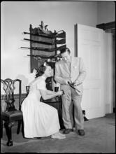 Billy Rose [Billy Rose handling a gun as Eleanor Holm watches.]