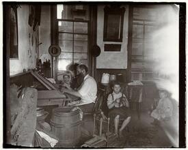 Bohemian cigar makers at work in their tenement.