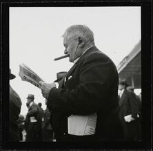 Aqueduct Race Track [Man reading a newspaper at the racetrack.]
