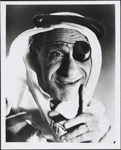 [Shimon Dzigan wearing a keffiyeh and eyepatch.]