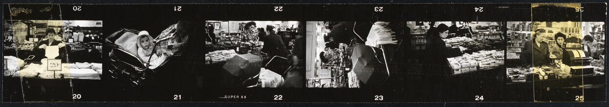 The 5 and 10 [People shopping and a child in stroller at Woolworth's.]