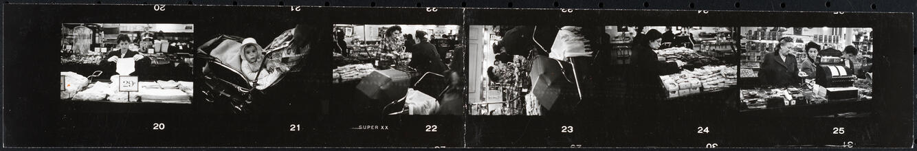 The 5 and 10 [People shopping and a child in a stroller at Woolworth's.]