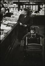 The 5 and 10 [Woman with a child in a stroller shopping at Woolworth's.]
