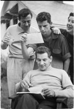 Leonard Bernstein [Leonard Bernstein looking at photographs with friends.]