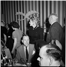 Champagne Cholly Book Party [People socializing at a party.]