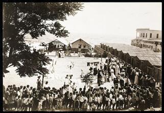 [Children lining up on the beach.]