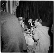 Champagne Cholly Book Party [Group talking at a table.]