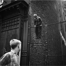 Shoe Shine Boy [Boy climbing a fence.]