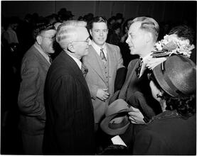 Dale Carnegie [Dale Carnegie talking with a group of people.]