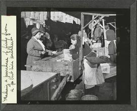 Making a purchase of fish from a[n] East Side pushcart.
