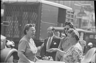 Street Conversations [Three women talking on the street.]