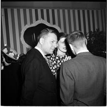Champagne Cholly Book Party [Woman and two men talking.]