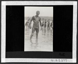 [Young man covered in mud.]