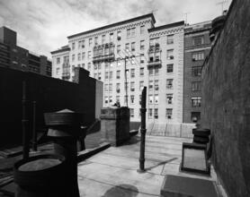 [Unidentified building with three visible balconets seen from rooftop.]