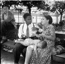 Steeplechase. [Couple with baby on a bench.]