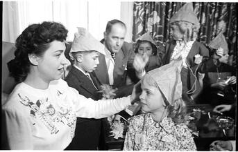 Deaf Children [Teacher putting a party hat on a girl.]
