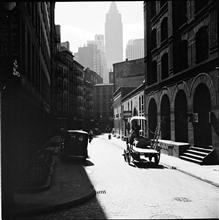 Waterfront. [Cart on a narrow street.]