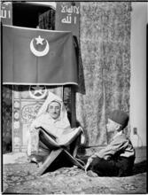 [Muslim cleric with a small boy.]