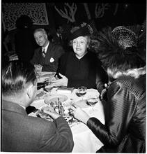 Champagne Cholly Book Party [People talking at a table.]