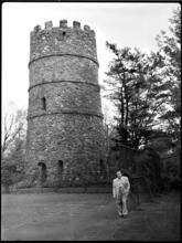 Billy Rose [Billy Rose outside a castle-like structure.]