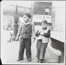 [Two boys on the corner of Madison Street and Pike Street.]