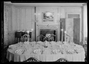 Carroll Carstairs [residence]. Dining room table set with candles lighted, light effect.