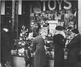 [Shoppers looking at Woolworth's window display.]