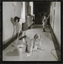 Orphanage [Girls cleaning a hallway.]