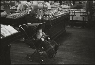 The 5 and 10 [Child in a stroller in Woolworth's.]