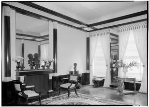 Elsie Cobb Wilson, Inc. Black and white room. Fireplace and 2 windows.