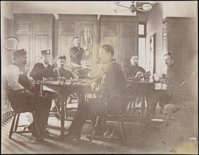 [Firemen sitting around a table.]