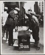 Newsboy selling the Sun
