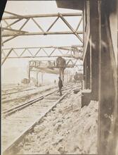 [Man standing on railroad tracks.]