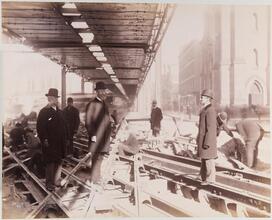 Construction of the cable road on Broadway, 1891 [Men standing on tracks.]