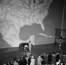 [Crowd inside of the Transportation building at the New York World's Fair.]