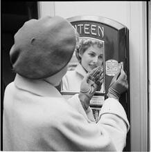 New York City Scenes: Fashion Shots [Fashionable woman inserting coins into a machine.]