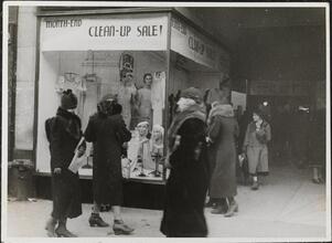 [Women looking at window display.]
