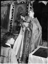 [Altar boy with a priest.]