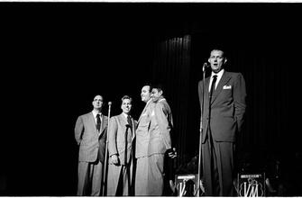 Vaughn Monroe [Monroe and a group of men singing on stage.]