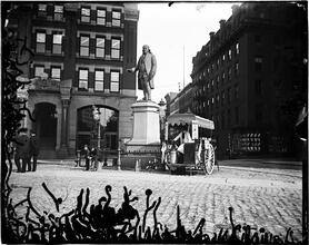 [Benjamin Franklin statue opposite City Hall, milk cart sitting adjacent]