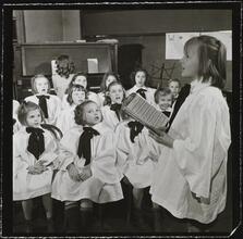 Orphanage [Girl singing in front of a choir.]