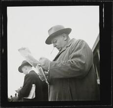 Aqueduct Race Track [Man reading a newspaper at a racetrack.]