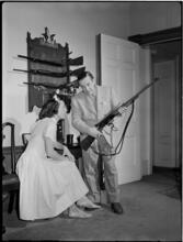 Billy Rose [Billy Rose handling a gun as Eleanor Holm watches.]