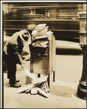 [East 40th Street and Madison Avenue. Man at overflowing mailbox.]