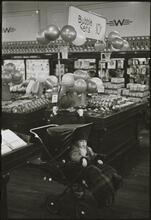 The 5 and 10 [Child in a stroller at Woolworth's.]