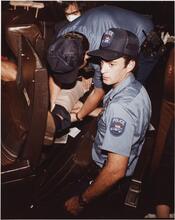 [Policemen performing first aid.]