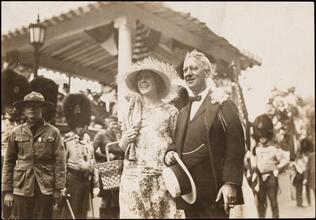 [Al Smith posing with a woman at an event.]