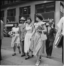 New York City Scenes: Fashion Shots [Group of women and men walking down the street.]