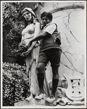 [Man standing next to unidentified monument.]