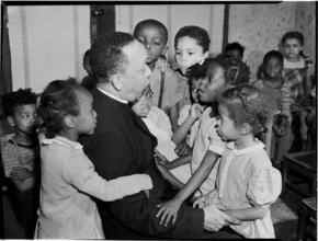 [Priest with children.]